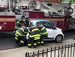 Firefighters Move A Smart Car Out Of Their Way
