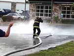 Fireman Tries To Catch A Wild Hose
