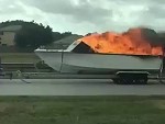 Flaming Boat Driving Down The Highway
