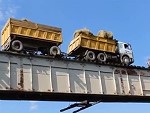 Large Truck Bravely Crossing A Train Bridge
