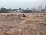 Surfer Makes The Most Of Raging Flood Waters
