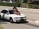 Woman Taking A Ride On The Hood Like Its Normal
