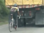 Brave Cyclist Letting The Truck Do All The Work
