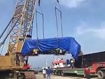 Cables Snap As They Crane A Train Onto A Truck
