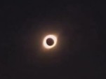 Crowd Gathers On A Beach To Watch A Spectacular Eclipse
