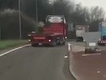Driver Runs After His Runaway Truck With A Length Of Timber

