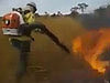 Fire Fighter Using A Blower To Put Out A Fire