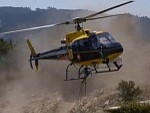 Fire Fighting Helicopter Refilling From A Nearby Pool
