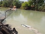 Fisherman Has To Compete With A Large Crocodile
