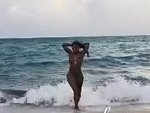 Beautiful Back Woman Emerges From The Surf Naked
