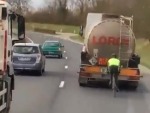 Idiotic Cyclist Drafting A Truck On The Freeway
