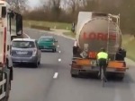 Idiotic Cyclist Drafting A Truck On The Freeway
