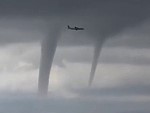Jet Casually Flies Past Three Tornadoes
