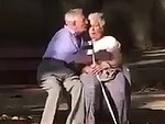 Old Couple Fooling Around On A Park Bench
