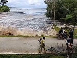 People Stand Around And Watch The Tsunami Approach
