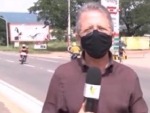 Riders Collide In The Background Of A News Report
