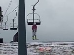 Skier Taking The Chairlift In An Unusual Way
