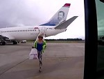 Stupid Girl Tries To Get Her Luggage Immediately As It Comes Off The Plane
