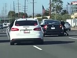 Woman Clinging To A Car On The Freeway
